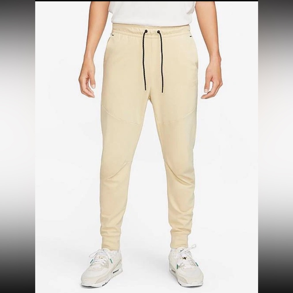 Nike Tech men’s essentials fleece joggers in tan with black details and zippers